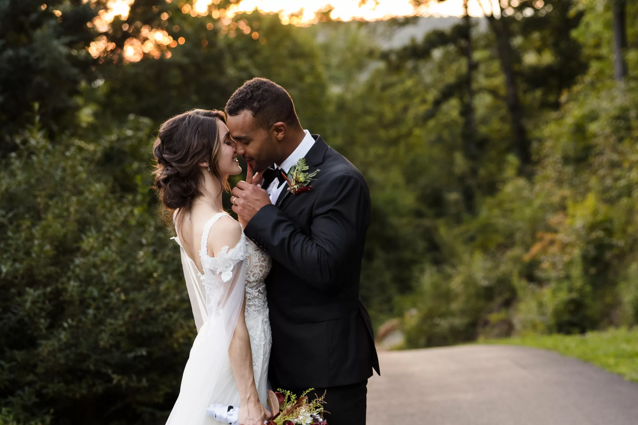 Bride and groom almost kissing at sunset