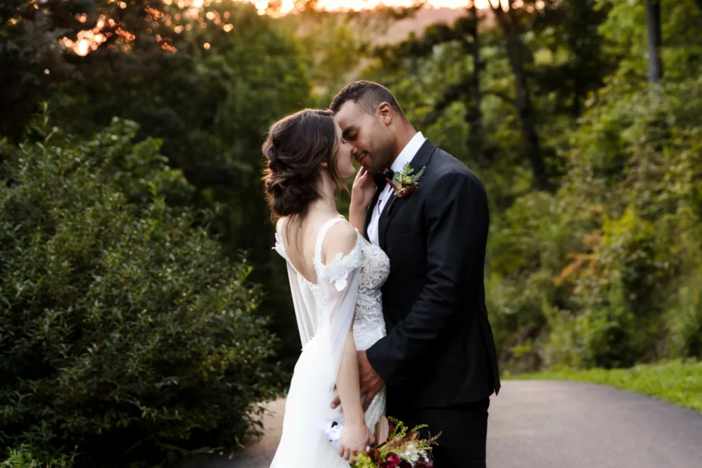 Bride and groom almost kissing at sunset